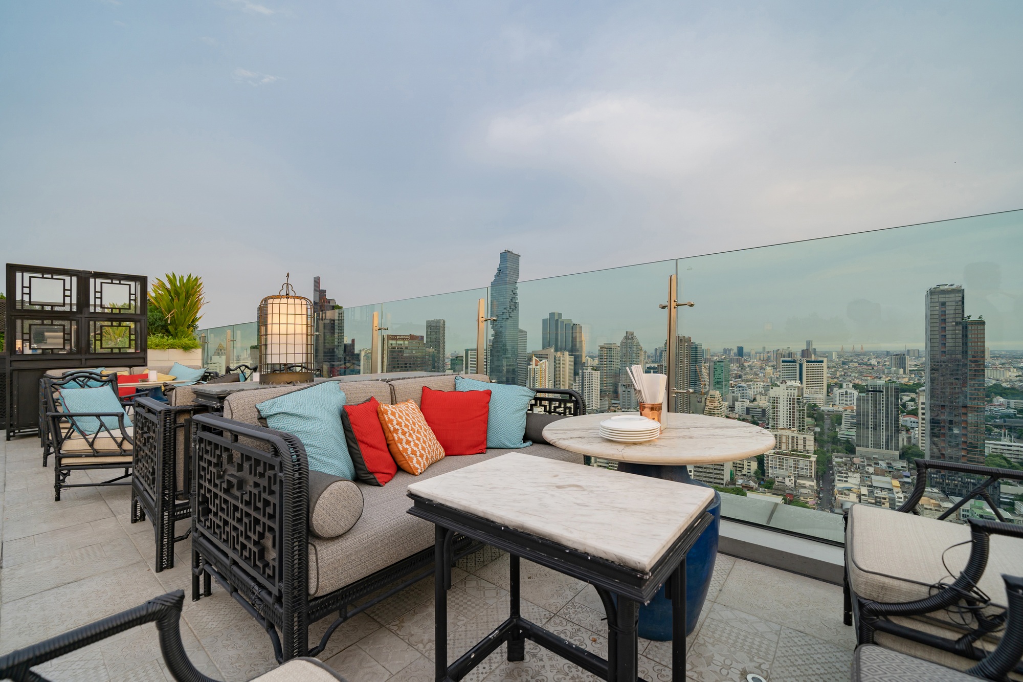 Sky bar, a restaurant or cafe lounge terrace with dinner table on rooftop of hotel, with city view