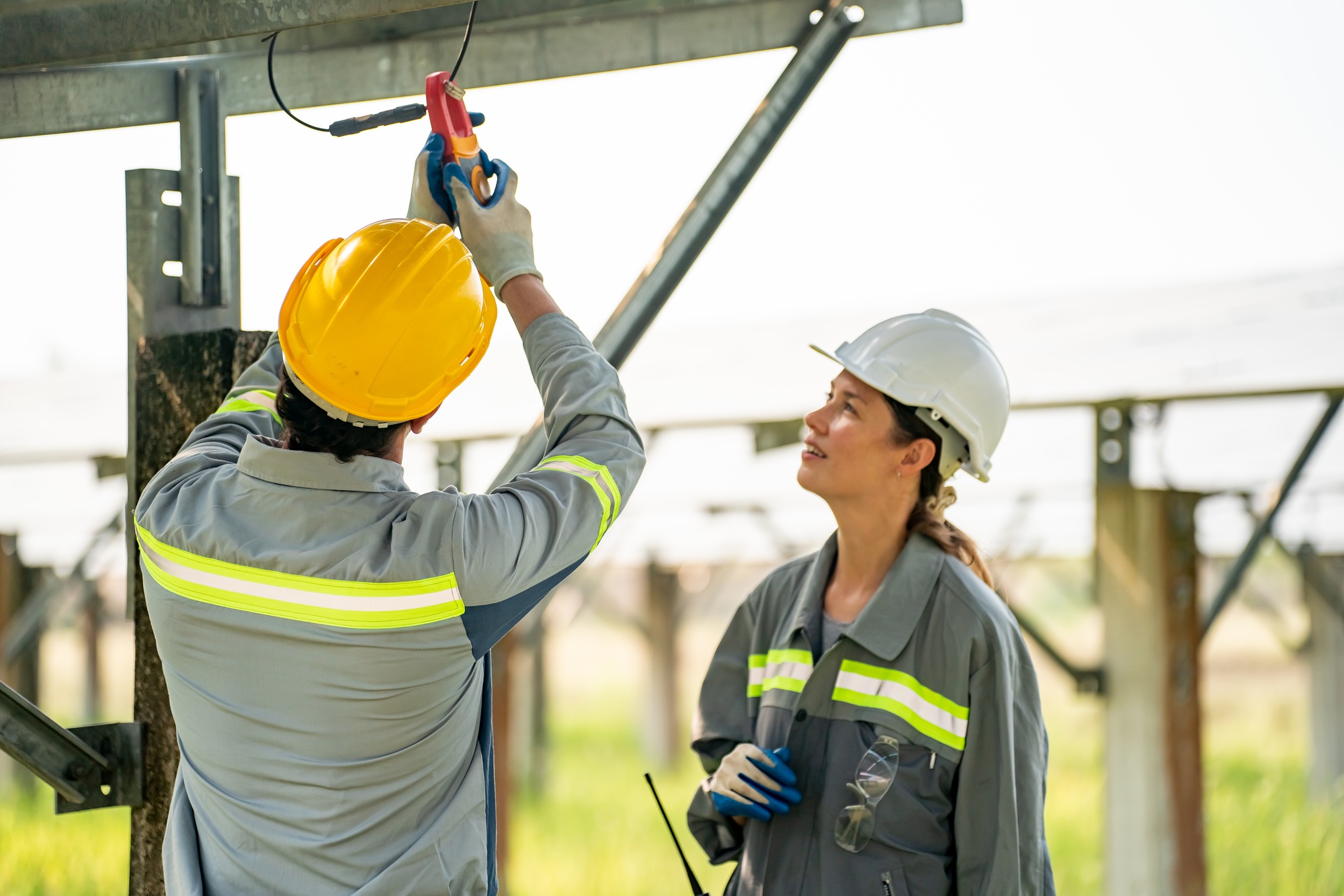 photovoltaic panel, Engineer with energy measurement tool photovoltaic modules for energy